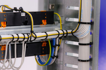 The reverse side of the electrical switchboard. Installation, by the method of wiring, of stranded wires.