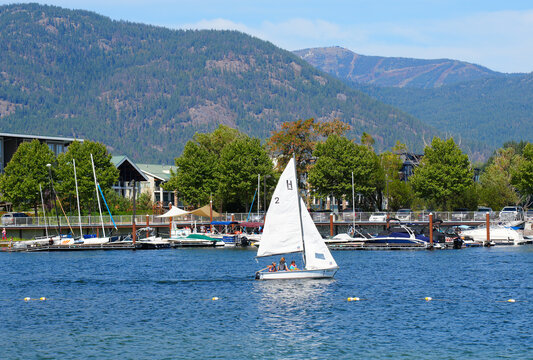 Sailboat leaving resort harbor