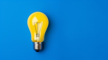 A yellow light bulb as the focal point on a vibrant blue canvas