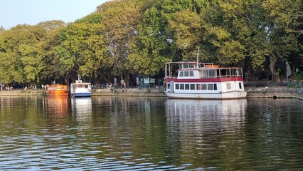 ioannina or giannena in autumn sesaon lake trees boats colors blue sky greece