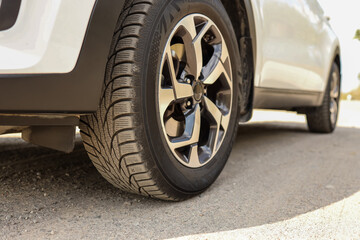 Fototapeta na wymiar Car wheels close up on a background of asphalt. Car tires. Car wheel close-up. for advertising