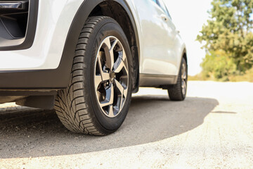 Fototapeta na wymiar Car wheels close up on a background of asphalt. Car tires. Car wheel close-up. for advertising