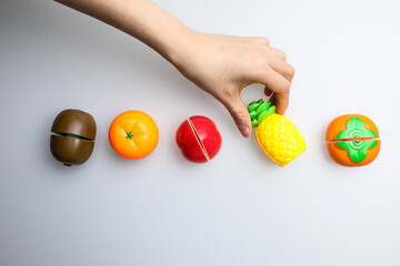 Fresh fruit, vegetables, delicious food, Sushi, 
Hamburger and pizza. Colorful educational toys from cute kids.