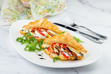 croissants with cheese, vegetables, cherry tomatoes and herbs