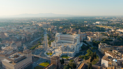 Fototapeta na wymiar Rome, Italy. Vittoriano - Monument to the first king of Italy, Victor Emmanuel II. Flight over the city. Panorama of the city in the morning. Summer, Aerial View