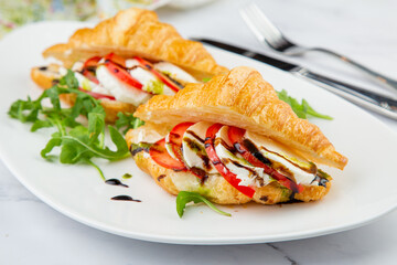 croissants with cheese, vegetables, cherry tomatoes and herbs