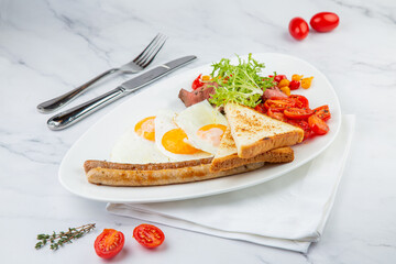 scrambled eggs with vegetables, cherry tomatoes, bread, herbs and sausages on a white plate side view