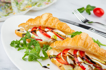 croissants with cheese, vegetables, cherry tomatoes and herbs