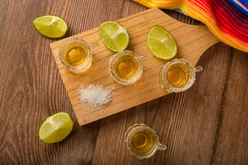 Tequila shots with salt and lime on a bar table. Shots of tequila and typical mexican elements.