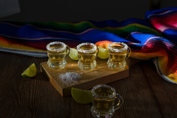 Tequila shots with salt and lime on a bar table. Shots of tequila and typical mexican elements.