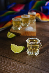 Tequila shots with salt and lime on a bar table. Shots of tequila and typical mexican elements.