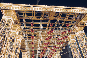 arch with illumination and christmas balls at night