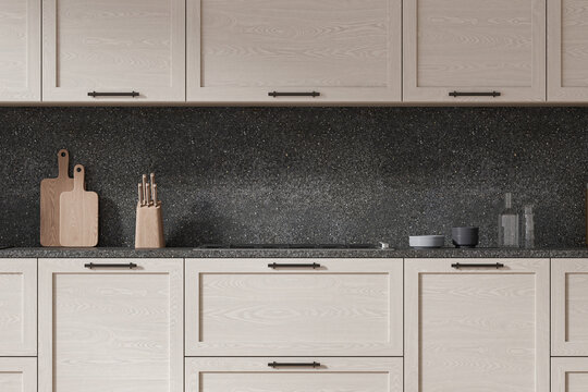 Wooden cupboards in dark gray kitchen interior