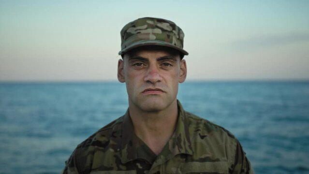 American soldier in camouflage smirks