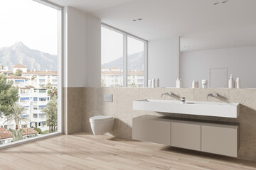 Fototapeta na wymiar Beige hotel bathroom interior with toilet and washbasin, panoramic window