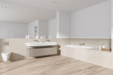 Fototapeta na wymiar Luxury hotel bathroom interior with toilet, washbasin and tub with accessories