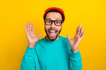 Portrait of speechless ecstatic man with beard dressed turquoise pullover staring at unbelievable...