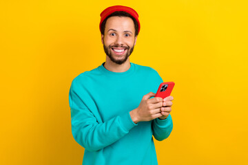 Portrait of impressed funky man dressed turquoise pullover hold smartphone impressed fast internet...