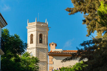 Naklejka premium Bell tower against blue sky, in Teulada, Alicante (Spain).