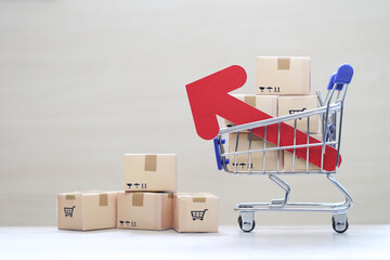 Global inflation or Deflation concept, Red arrow graph and brown parcel box on model miniature...