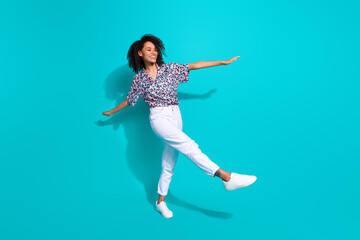 Full length photo of cheerful optimistic girl going walking enjoying weekend free time isolated on cyan color background