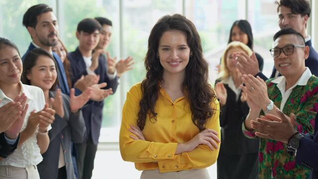 Multiracial group of diversity business people in row applauding or clapping hands to congratulate woman boss winner to success achievement goal.
