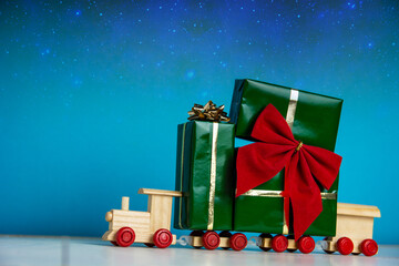 toy train filled with christmas gifts presents - New Year Merry Christmas greeting card celebration old vintage craft styling background	
