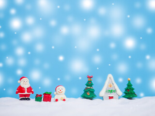 Santa claus and Snowman in the town with shiny light for Christmas and New Year holidays background, Winter season, falling snow, Copy space for Christmas and New Year holidays greeting card.