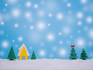 Christmas tree, Miniature house with shiny light for Christmas and New Year holidays background, Winter season, falling snow, Copy space for Christmas and New Year holidays greeting card.