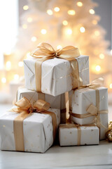 Wrapped Christmas presents in light and neutral colors set up in a decorate setting for the holiday season