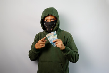 Thief holding paper money isolated on white background.