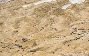 Texture and relief of limestone and chalk layered mountain slopes in Mangistau, hills with ditches...