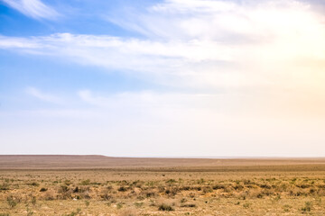 Fototapeta premium Minimalistic landscape of the Kazakh steppe in Mangistau in May, steppe of the Ustyurt plateau