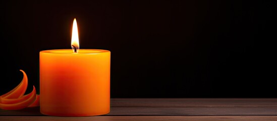 Stock photo of a candle glowing in orange light With copyspace for text