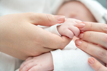 Mother's reassuring touch calms a sick newborn. Concept of the healing power of maternal bond