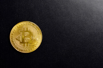 Top view of bitcoin on black background with text space