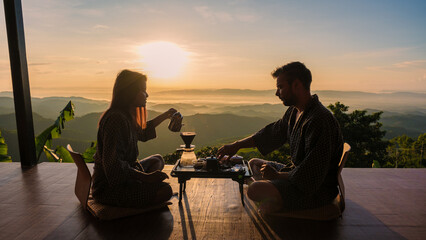 a couple on vacation in Thailand waking up with drip coffee in the morning, with a look at the mountains of Doi Chang Chiang Rai Thailand - obrazy, fototapety, plakaty