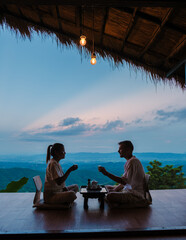 a couple on vacation in Thailand waking up with drip coffee in the morning with a look at the...