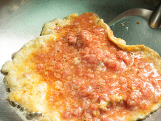 frying egg with minced pork meat