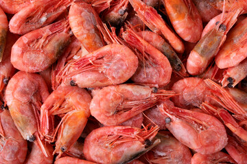 Shrimp background. Frozen boiled shrimps. Seafood product. Full frame. Top view