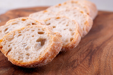 Baguette sliced on wooden board. Fresh homemade bread. Copy space