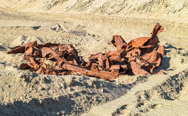 Rusty Twisted Metal Structures Lying on the Sand