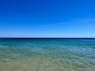 Blue sea horizon, transparent sea surface with ripples, clear blue sea and blue sky