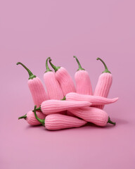 Hot peppers, pastel pink, knitted, minimal, aesthetic, creative food composition