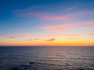 Beautiful purple ocean view, sky after the sunset, pink clouds, sea horizon, ocean coast 