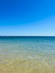 Fototapeta na wymiar Blue sea horizon, transparent sea surface with ripples, clear blue sea and blue sky