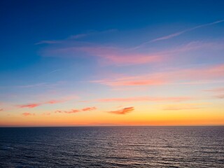 Beautiful purple ocean view, sky after the sunset, pink clouds, sea horizon, ocean coast 