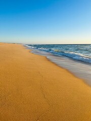 Blue sea horizon, clear sky, sandy coast