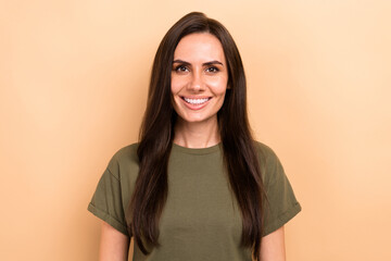 Photo of pretty good mood woman with straight hairdo dressed khaki t-shirt toothy smiling at camera isolated on beige color background