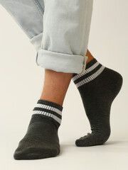 black and white socks with copy space on human feet closeup photo on white background